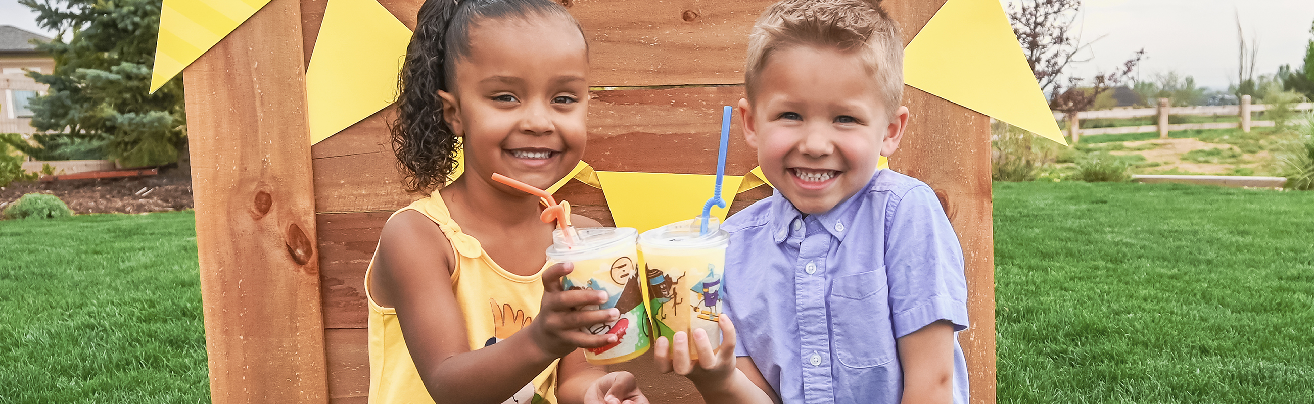 Two kids holding a Ziggi's kidZone drink