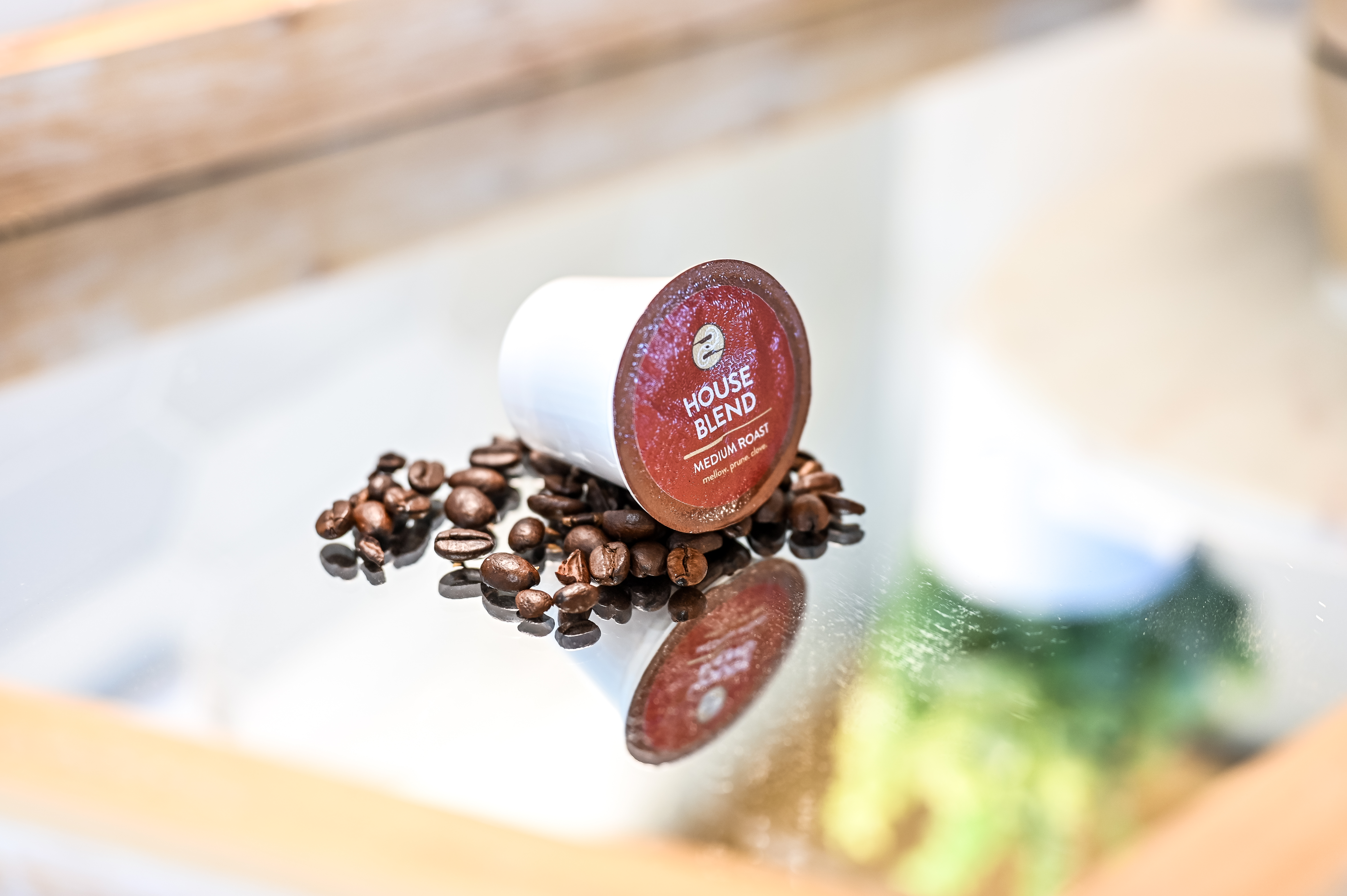 Ziggi's single serve pods with coffee beans around it