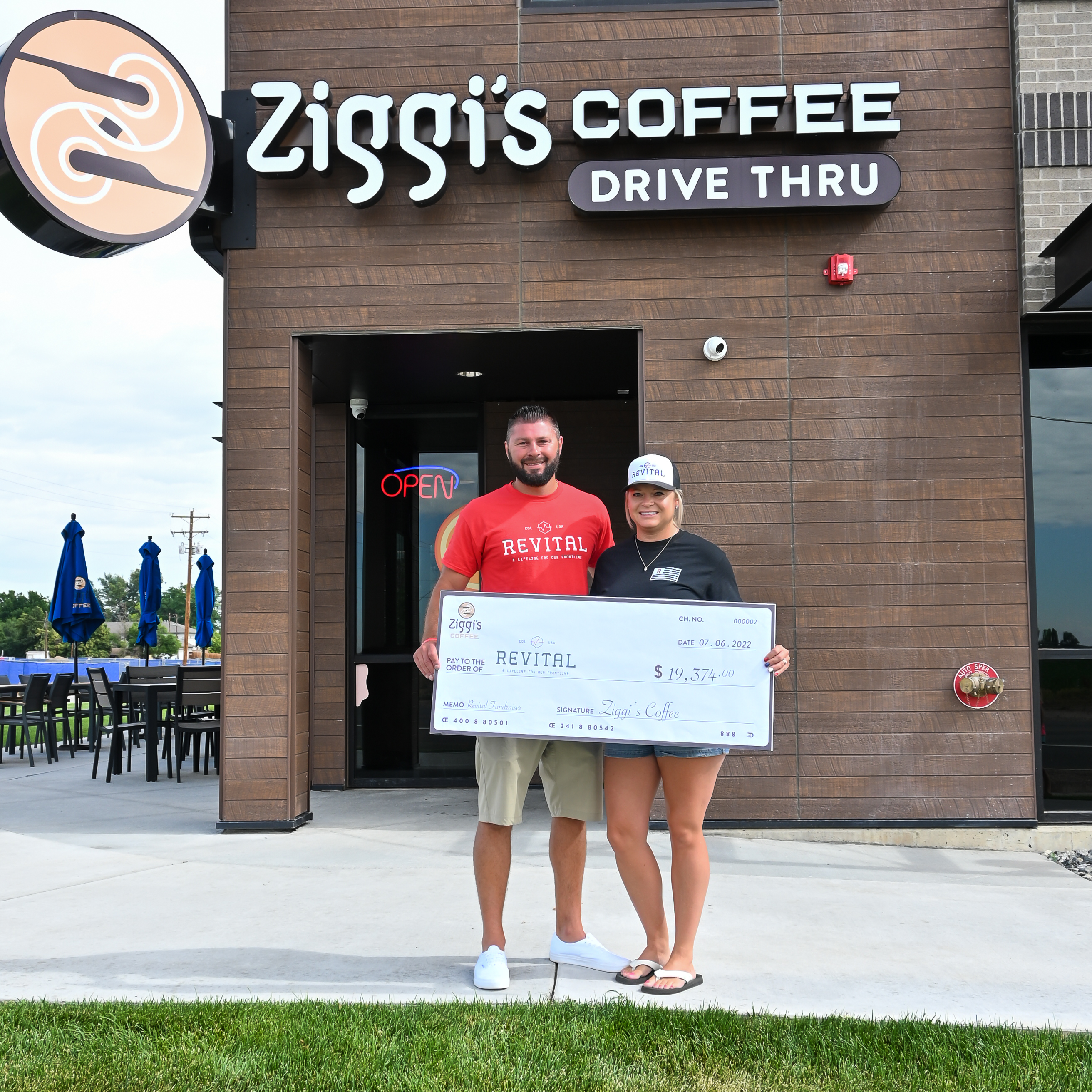 Revital Founder, Jordan Long is presented with a donation from Ziggi's Coffee. 