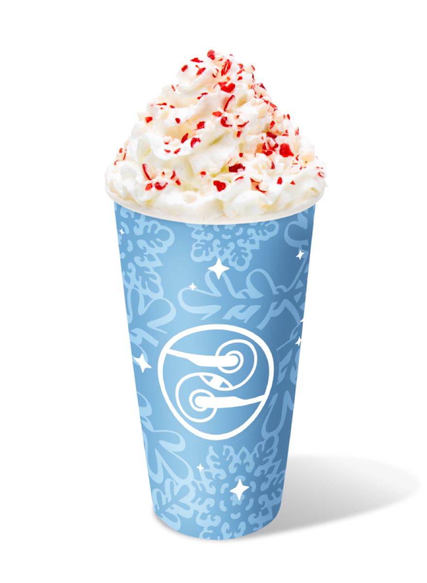 Hot Candy Cane Crunch Latte topped with whipped cream and crushed candy canes in a blue Ziggi’s holiday cup.