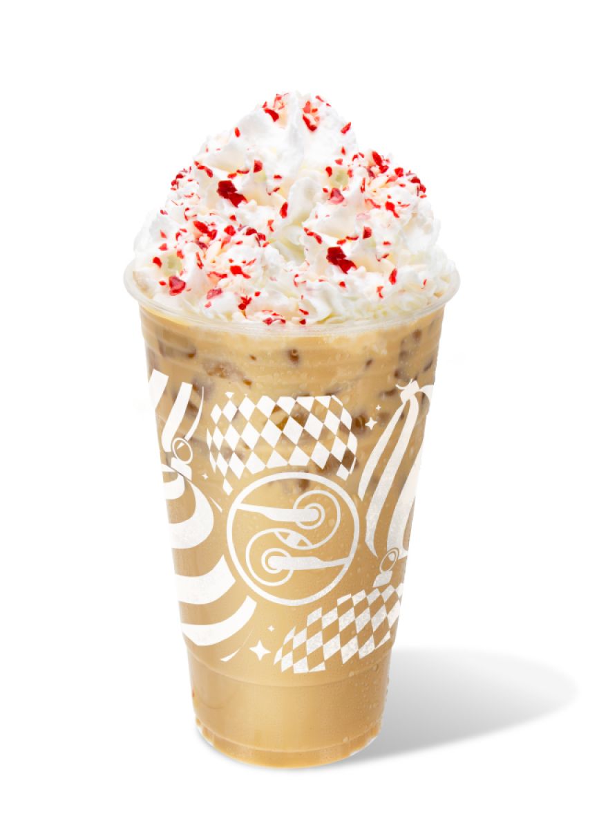 Iced Candy Cane Crunch Latte topped with whipped cream and crushed candy canes in a festive Ziggi’s holiday cup.