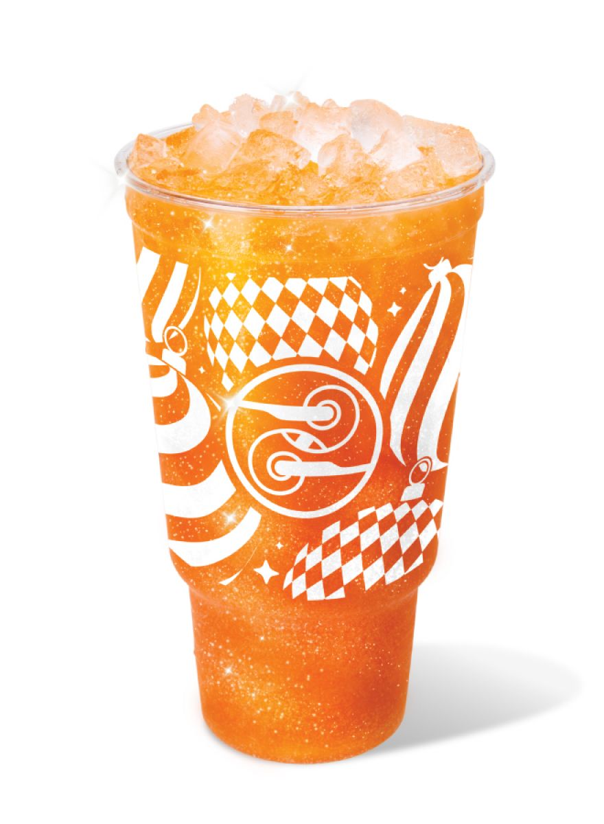 Sparkle & Spice Dirty Soda with orange, pomegranate, cinnamon, and edible glitter in a festive Ziggi’s holiday cup.